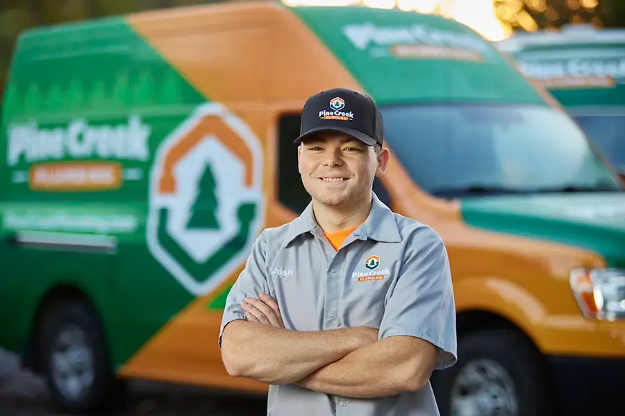 Pine Creek Plumber smiling in front of truck