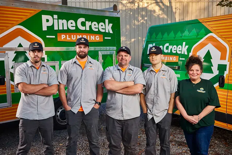 Pine Creek plumbing team with trucks in background
