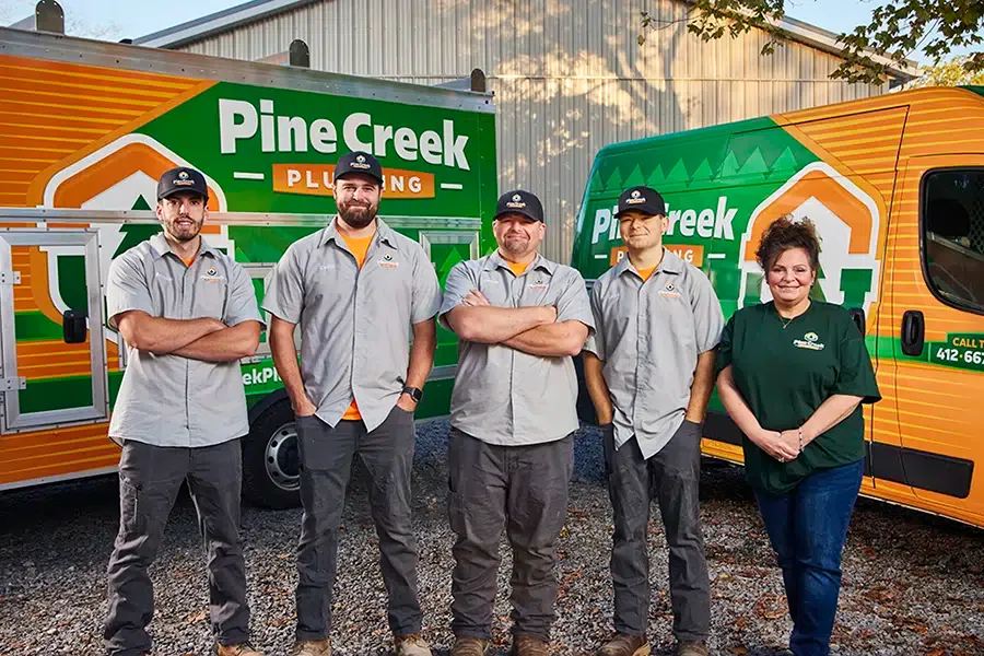 Pine Creek plumbing team with trucks in background